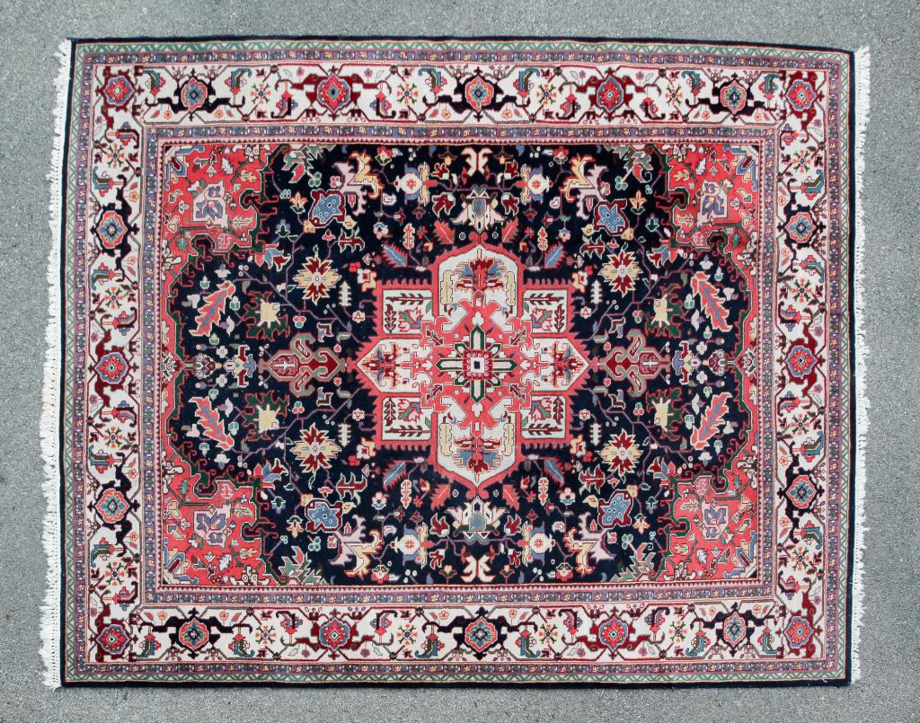 ROOM SIZE HERIZ RUG.: Late 20th century, wool. Blue field with coral and ivory medallion and ivory border. 8'1" x 10'1".