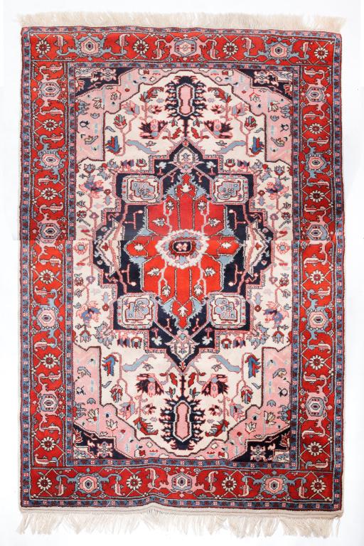 ROOM SIZE HERIZ RUG.: Late 20th century, wool. Ivory field with rust border and rust and blue medallion. 6' x 8'11".