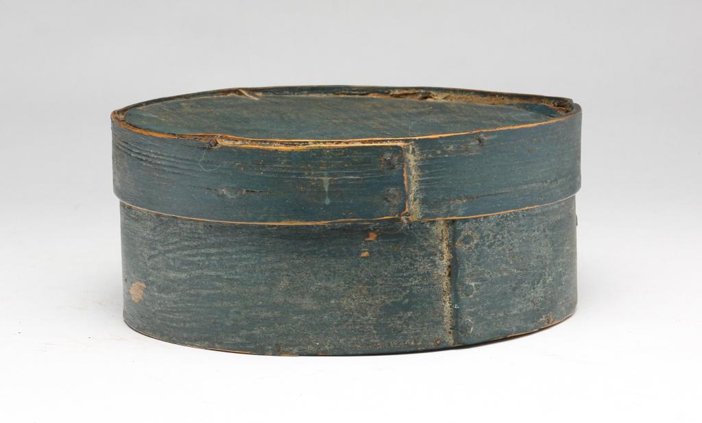 ROUND PAINTED BENTWOOD PANTRY BOX: American. Second half 19th century. Round bentwood box with lapped seams and iron tacks. Old paint. Blue/green. Wear, splits and loss. 6.75"w. 2.75"h.