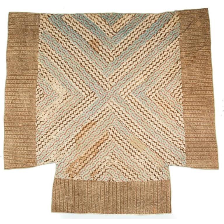 AMERICAN QUILT.: Second half-19th century. Printed floral cloth in diagonal stripes with wide brown border. Wear. 76" x 100".