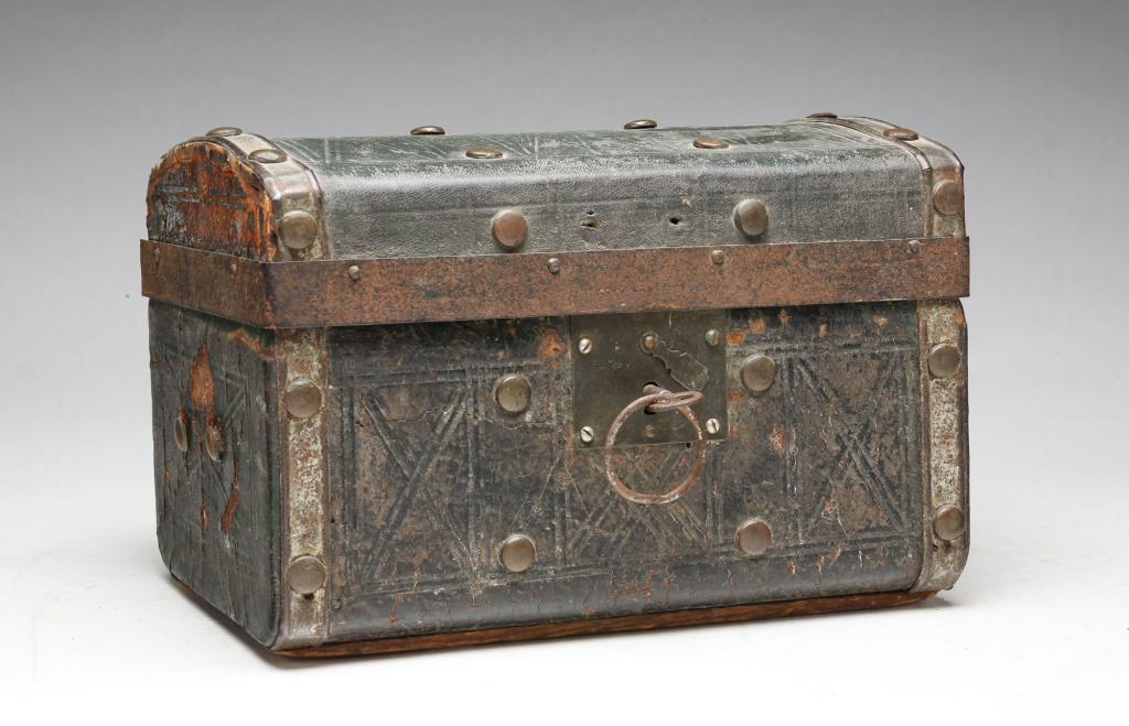 AMERICAN LOCK BOX.: Mid 19th century, pine. Dome top box covered in tooled green leather and brass tacks. Interior and lift out lid covered in paper. Worn, loss, lock sticks. 7"h. 10"l.