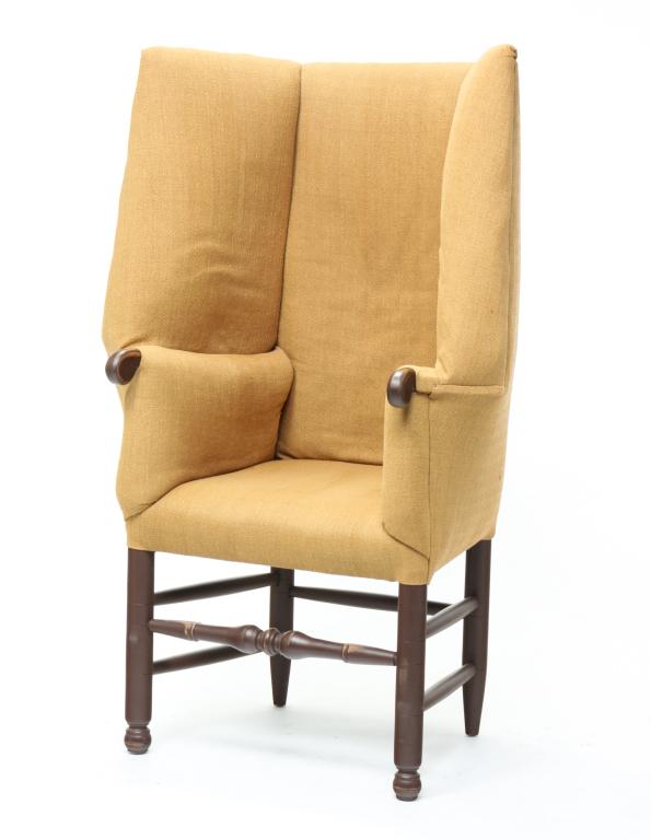 AMERICAN COUNTRY WINGBACK CHAIR.: Late 20th century, maple. In the 18th century style with dull gold upholstery, rolled arms, turned legs and rungs with distressed red-brown paint. 19" seat, 50"h.
