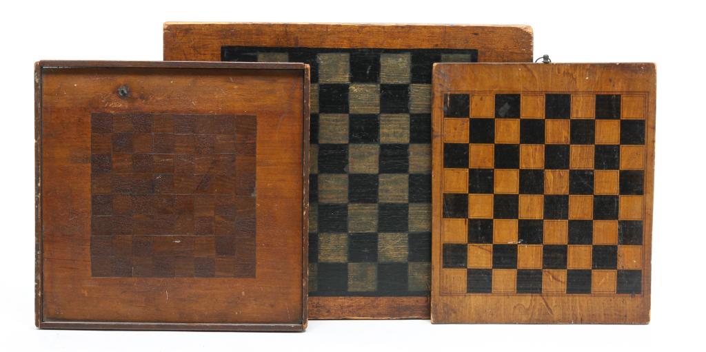 THREE AMERICAN DECORATED GAMEBOARDS.: Ca. 1900. Single side boards. Checkers in black and white. 18.25" x 14.5". Checkers in black and natural. 13" x 11". Checkers in natural 13.25" x 13.25". Varying wear.