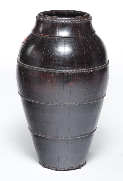 CHINESE WOODEN WINE VESSEL.: Early 20th century. Stave construction with braided leather bands. Late dark stain. Some surface scuffs and edge loss. 23.75"h.