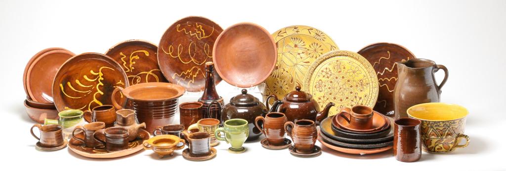 LARGE GROUP OF REDWARE POTTERY.: American and English, mid 19th-late 20th century. Includes period pie plates, and pitcher, two early 20th century English teapots and several pieces of reproduction plates, dishes and cups inlcuding s