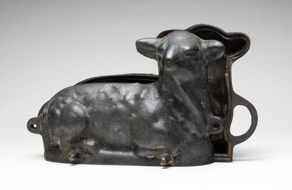 AMERICAN CAST IRON LAMB MOLD.: Twentieth century. Two piece lamb mold. "Schaab, stove & Furn. O.2024 S. Bway" to the bottom. 13"w. 8"h.