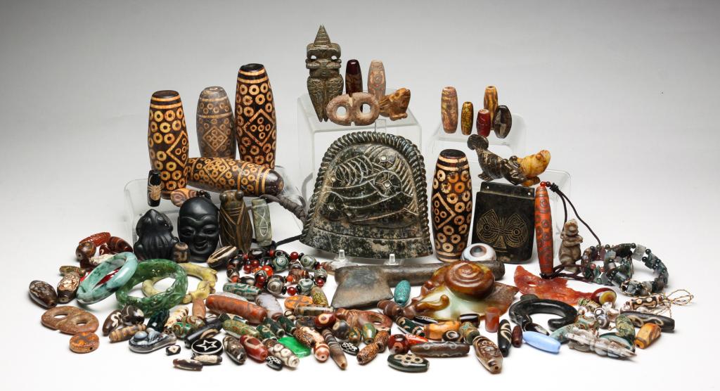 LARGE GROUP OF BEADS, BANGLES AND CARVINGS.: Twentieth century. Ethnic glass and pottery beads, Asian carved agate pendants and bangles including probable jade, and assorted carvings including snail, axe and coins. Varying wear and loss.