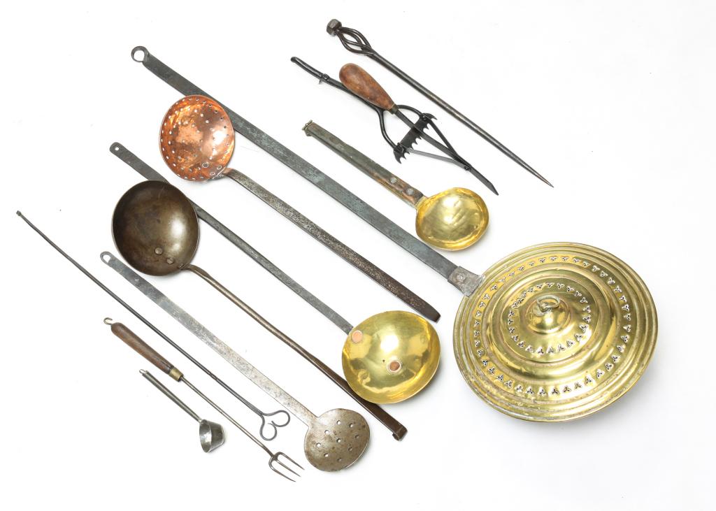 GROUP OF KITCHEN UTENSILS.: American and European, 19th century. Including wrought iron, brass and copper pieces. Pierced brass lidded warmer, brass bowled ladles, copper strainer, wrought iron tools, etc. Varying wear. 6"l to 3