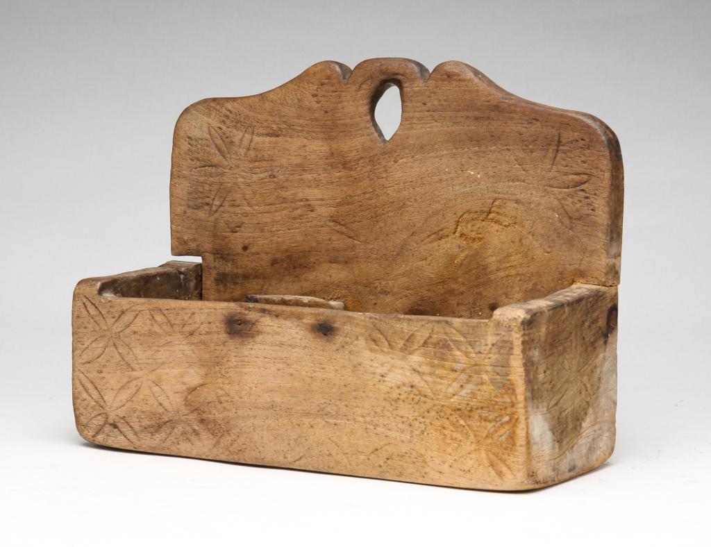 AMERICAN HANGING WALL BOX.: Mid-19th century. Box carved from single piece with attached back. Incised compass stars and punched diamonds. Decorative crest. 8.25"h. 11"w. 4.25"d.