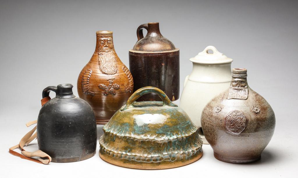 SIX AMERICAN POTTERY AND STONEWARE PIECES.: Late 19th-late 20th century. Two stoneware jugs, 7" to 10"h., white glazed water cooler, 10.5"h. and two late bellarmine jugs, 9", 10"h. Together with a glazed cooking pot lid.