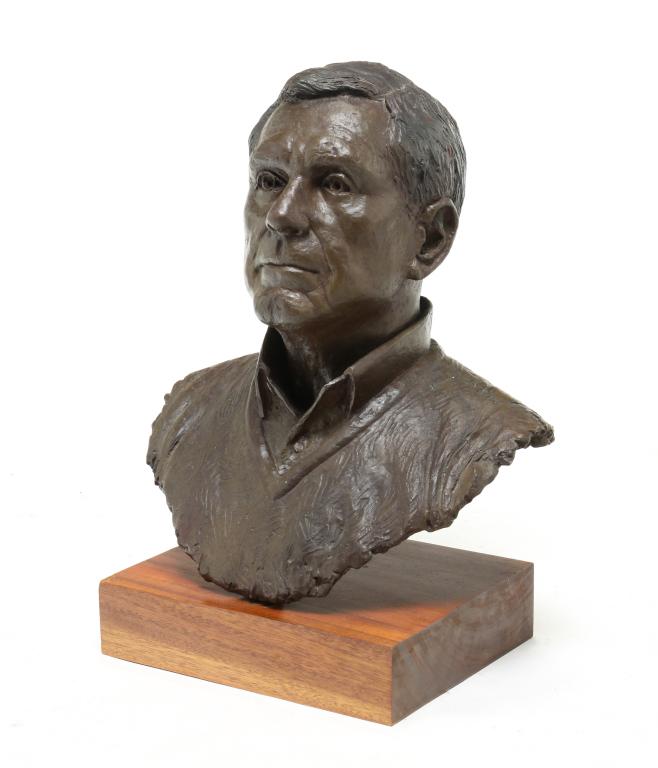 BRONZE BUST OF A GENTLEMAN.: Second half 20th century. Nicely cast man wearing shirt and sweater. On a mahogany base. 22"h. 17.5"w. 12"d.