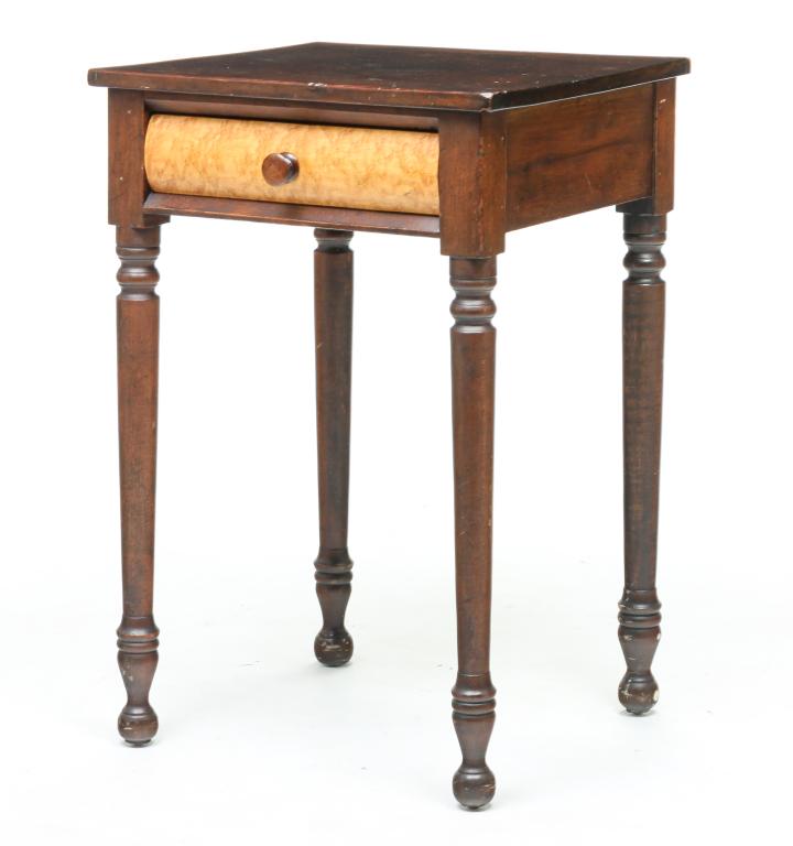 AMERICAN SHERATON STAND.: Second quarter 19th century, cherry and birds' eye maple with poplar secondary. Dovetailed drawer with rounded front and turned legs. Refinished with some wear and repaired left-front leg. 29.25"h. 19