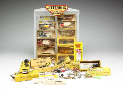 TWENTY-FIVE FRED ARBOGAST FISHING LURES.: American, 20th century. Including "Jitterbugs", "Hawaiian Wigglers", "Arbo-Gasters" and a "Tin Liz" with glass eyes.