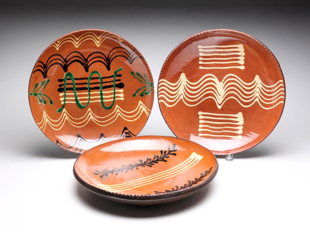 CONTEMPORARY AMERICAN REDWARE CHARGERS.: Ohio. Turtle creek redware. Quill slip decoration. Dated 2008, 2018 and 2020. Sizes vary 12.5" - 13"w.