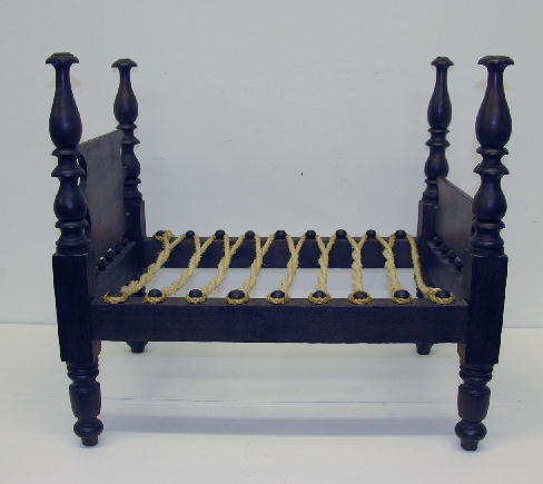 ANTIQUE CHERRY DOLL'S FOUR- POSTER ROPE BED, 18"H,: ANTIQUE CHERRY DOLL'S FOUR- POSTER ROPE BED, 18"H, 20"L, 14"W. Nicely turned legs and posts, all rope pegs present. A few old mars in wood, top of each post darkened, good patina.