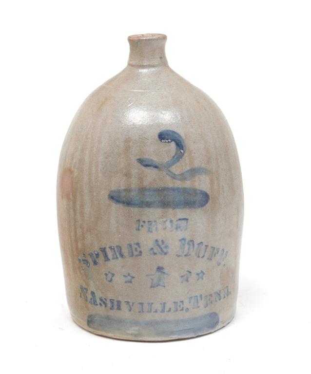 TWO-GALLON STONEWARE JUG LABELED "NASHVILLE".: American, 2nd half-19th century. Applied handle, grey glaze with freehand cobalt "2" and stenciled merchant label with stars and "From Spire & Duff. Nashville, Tenn.". Faint crows feet under handle. 1