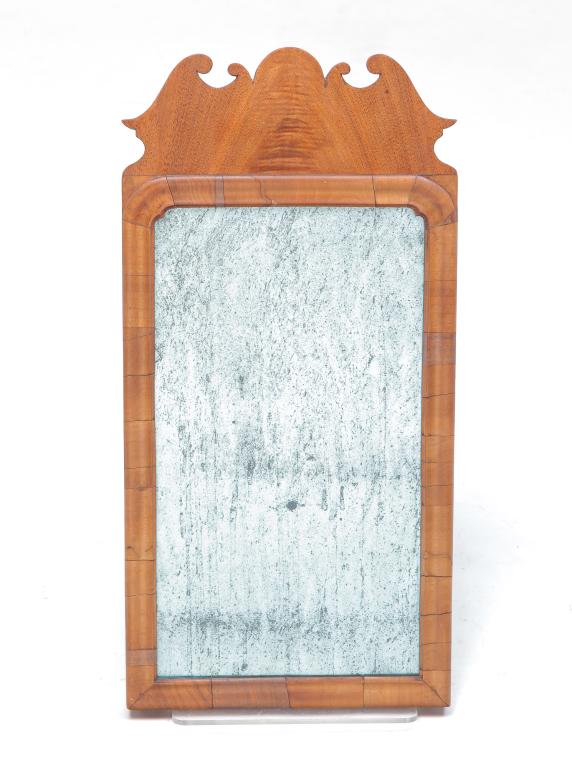 QUEEN ANNE MIRROR.: Probably English, mid 18th century, mahogany veneer. Molded liner and scrolled crest. Old, if not original, mirror. Refinished, veneer splits. 21.75"H. 10.5"w.