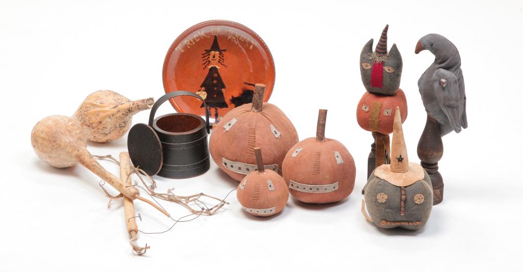CONTEMPORARY AMERICAN AUTUMNAL FOLKSY PIECES.: Including four cloth stuffed pumpkins, 6.25" - 10"h., crow on stand, 16"h., cat and pumpkin on wood stand, 17.5"h., a Turtle Creek trick or treat redware charger, 11.75"h., a painted miniature sugar b