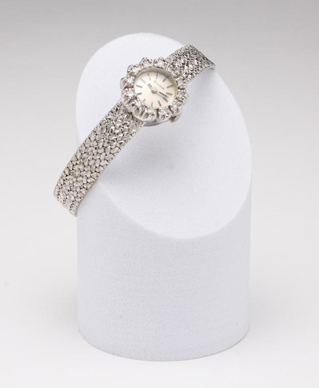 VINTAGE LADIES 14K AND DIAMOND WRISTWATCH.: Mid-20th century. Ladies 14K white gold Bulova wristwatch, 17J (unadjusted), small round face approx. .50" diameter, with outer ring of twelve single cut diamonds, approx. .30ct total weight. Integrat