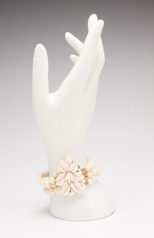 WHITE CORAL BEAD BRACELET WITH GOLD CLASP.: 20th century. Vintage four-strand white coral bead bracelet, knotted, with 14K yellow gold clasp with safety catch (tested electronically), top of clasp with carved coral. Coral beads approx: 6mm diam
