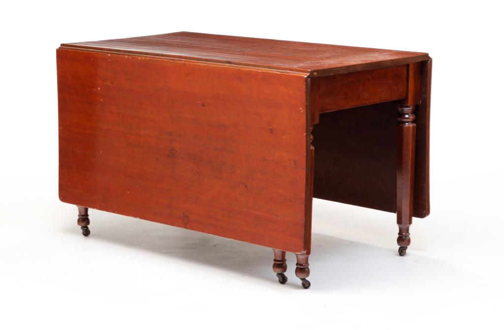 AMERICAN TRANSITION DROP LEAF TABLE.: Second quarter 19th century, cherry. Sheraton to Empire, long chops, six turned and paneled legs. Refinished with warping to leaves. 29"h. 48"w. and opens to 71.5" with 23" leaves.