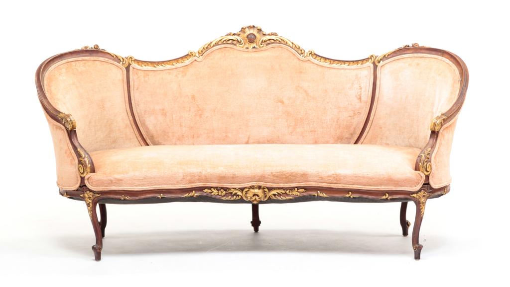EUROPEAN LOUIS XV STYLE SOFA.: First quarter 20th century, walnut. Floral, leaf bracket and finger carving with gilding and velvet upholstery with corded trim. Repairs especially to back legs. 16" seat ht. 36"h. 72.5"w.