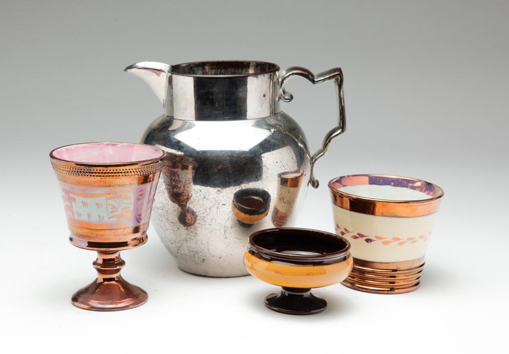FOUR PIECES OF ENGLISH LUSTER.: Nineteenth century. Copper luster goblet with pink luster scenic band, 4.5"h.; copper luster beaker with tan band, 3"h.; master salt with tan band, 2"h., and a silver luster pitcher (wear), 6.5"h.