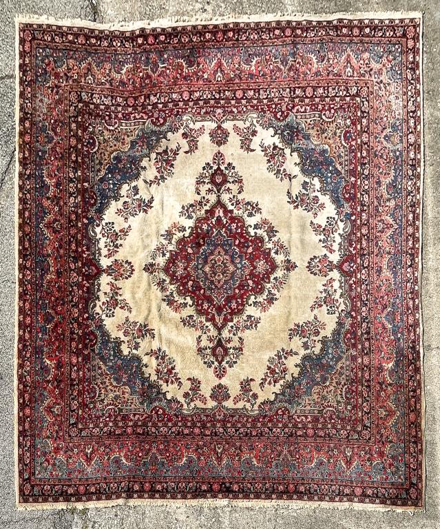 PERSIAN STYLE RUG.: Second half 20th century. Room size. Ivory ground, wide blue and pink borders. Light stains. 11'7" x 12'2".