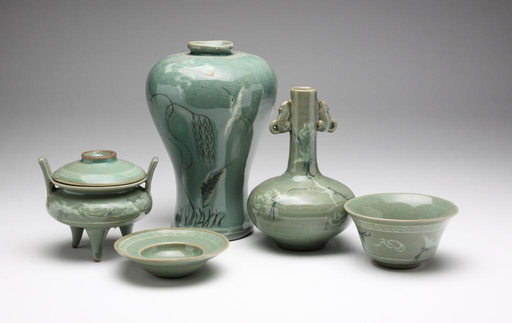 FOUR PIECES OF CONTEMPORARY KOREAN POTTERY.: Mid 20th century. Song-style pieces with green glaze, impressed marks and crane decoration. Two vases, 6.5", 7.75"h., covered dish, and vessel (missing lid).