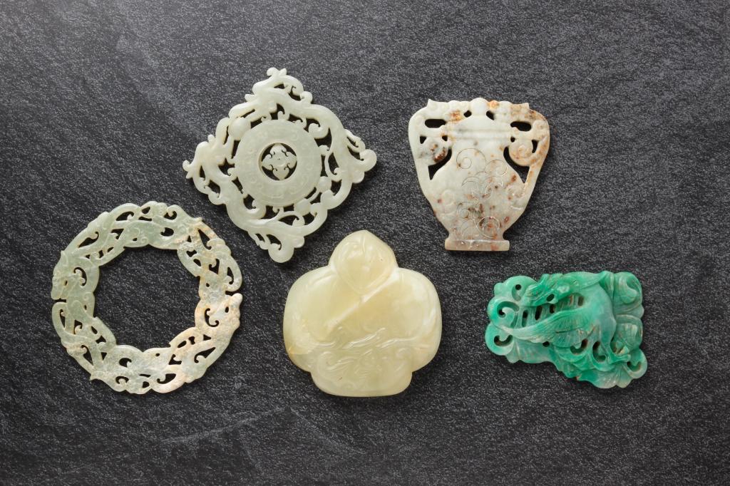 FIVE CHINESE STONE CARVINGS.: Twentieth century. Includes jade. Bat with fruit, 3"w., green bird, 3.5"l., urn, figural bi disk, 3.75"d. and a square with rotating center, 3" x 3".