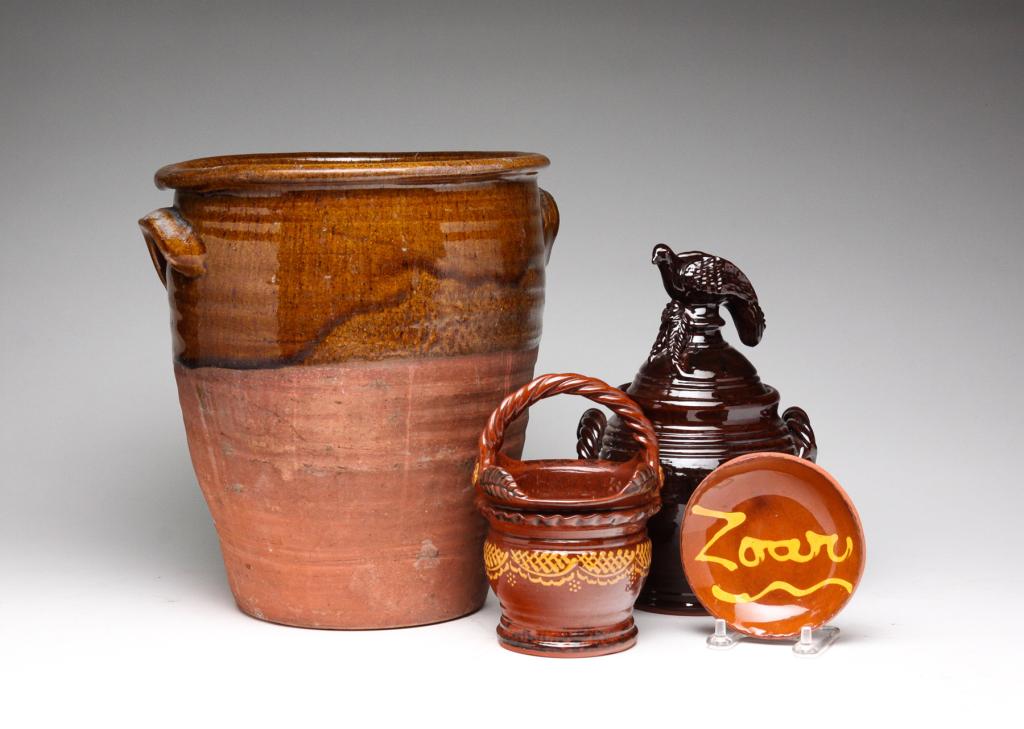 FOUR PIECES OF AMERICAN REDWARE.: Second half 19th-early 21st century. Crock with applied handles and glazed top and interior. 10.75"h. And three marked contemporary folk art pieces. Basket and jar with dove lid by Foltz pottey. 6.25"