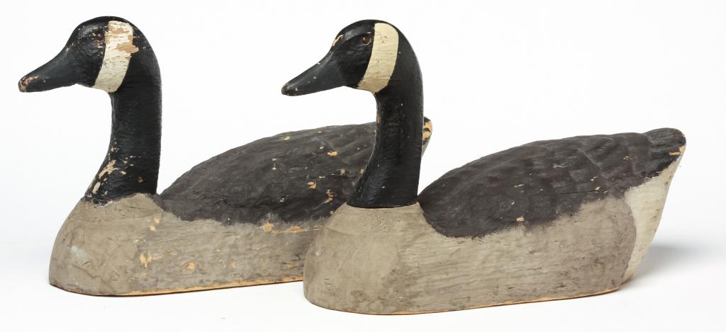 TWO AMERICAN CANADA GOOSE DECOYS.: Mid 20th Century, balsa wood. Full sized, carved and painted in white, grey and black. Some paint loss and edge loss. 11"h 19.5"l.