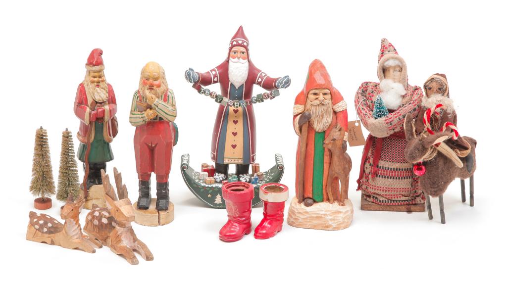 GROUP OF CONTEMPORARY FOLKSY CHRISTMAS FIGURINES.: Including carved wood Santa's, a plush Santa wearing coverlet coat, two carved reindeer and a soft body Santa riding a reindeer. Also includes two boots with tree decorations. Varying wear.