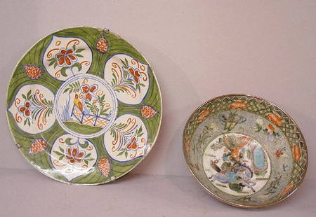 TWO CERAMIC PIECES. Large faience charge: TWO CERAMIC PIECES. Large faience charger in green, red and blue decoration. Includes a bird on a fence at the center surrounded by floral panels. Edge chips. 13 1/2"d. Oriental style bowl with