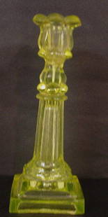 CANARY GLASS CANDLESTICK. Stepped base,: CANARY GLASS CANDLESTICK. Stepped base, fluted column and a petal socket. Rough base and repaired socket. 9 1/2"h.