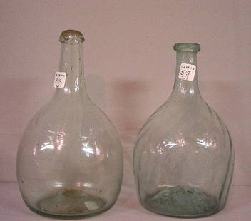 TWO PALE AQUA BOTTLES. Mantua club with: TWO PALE AQUA BOTTLES. Mantua club with sixteen swirled ribs. Applied lip. Wear and some residue. 8"h. And a very pale, plain bottle with applied lip. Some residue. 8 1/2"h.