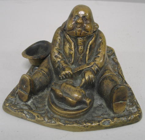BRASS FIGURAL INKWELL. Portly man sitting on the
