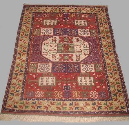 ORIENTAL RUG. Kazak with cream center medallion a