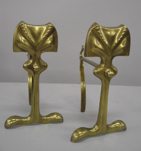 PAIR OF BRASS FIRE DOGS. Art Nouveau with a forme