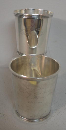 TWO JULEP CUPS. One is coin silver marked "D. Kins: TWO JULEP CUPS. One is coin silver marked "D. Kinsey" (David Kinsey, Cincinnati, ca.1817-1860). Engraved "Robert Lyle-Irvine Premium 1869". 3 3/8"h. And "Sterling Silver...Duhme & Co." Small dents. 3
