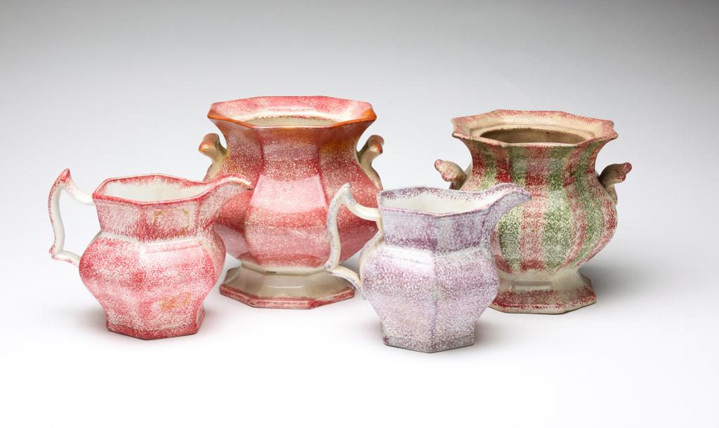 FOUR PIECES OF ENGLISH SPATTERWARE.: Mid 19th century. Two creamers. One red, 4.5"h., and one purple, 4.25"h. Two sugars, no lids. Peafowl, 5.75"h. and red and green, 5.5"h. Varying wear, loss and stains.