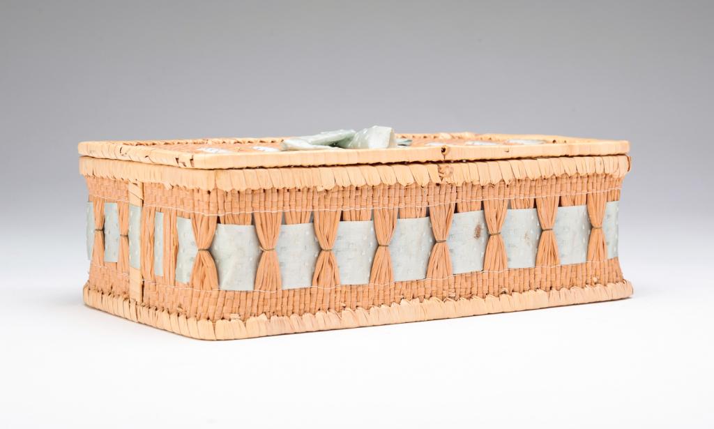 SHAKER BASKETRY BOX.: Early 20th century. Woven basketry box with interlaced ribbon and a bow on top. Some minor loss including a tear in the ribbon. 2.75"h. 8.75"w. 5"d.