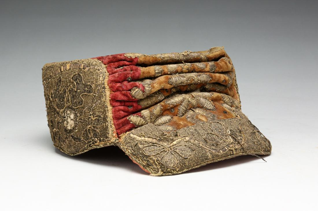 EASTERN POSSIBLY UZBEK EMBROIDERED CAP.: Late 19th-early 20th century. Velvet cap with bill and floral metallic thread embroidery. Faded with wear. 3.5"h.