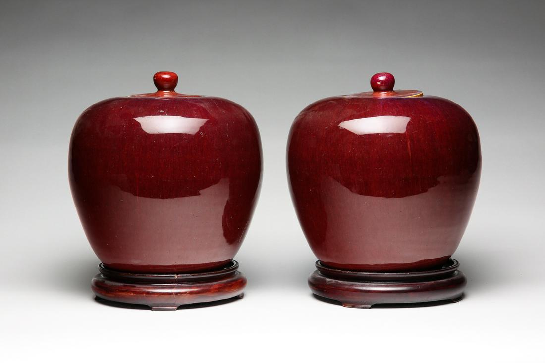 PAIR OF CHINESE SANG DE BOEUF GINGER JARS.: Most likely 19th, possibly 18th century. Porcelain with matching glaze. Edge flakes on lids and table rings. 8.75"h.