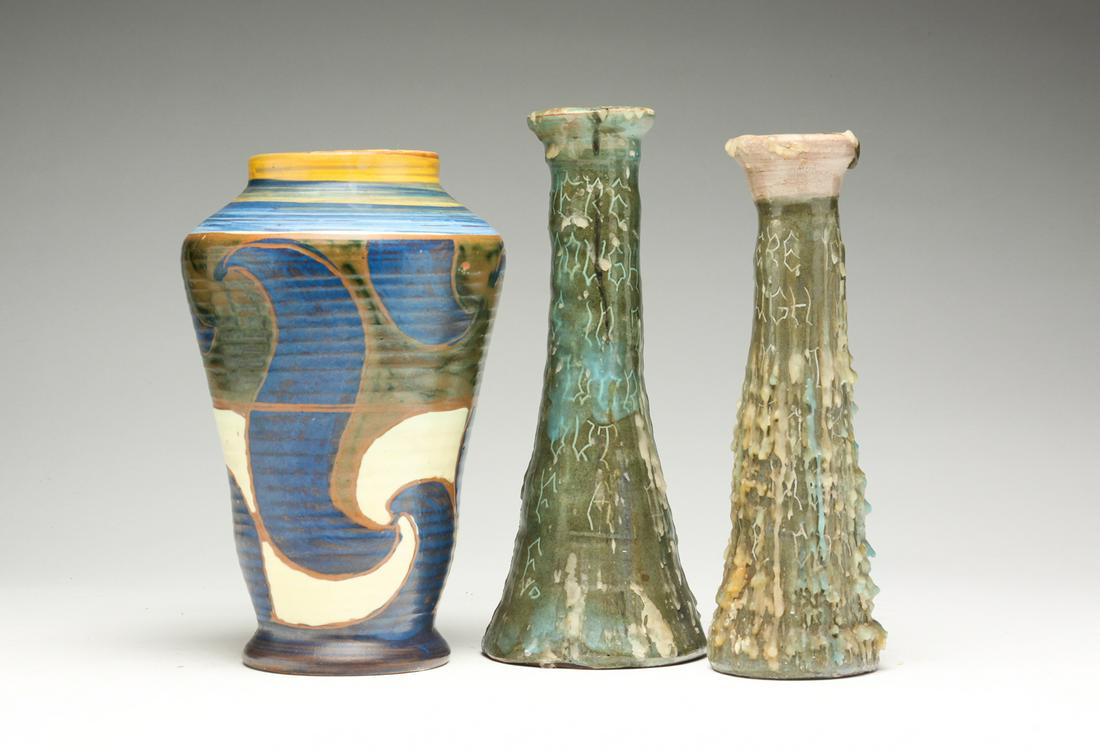 THREE PIECES OF ART POTTERY.: Twentieth century. Swedish Upsala Ekeby vase marked "UE Sweden 1833", 8"h. And a two candlesticks, one marked "Graylor", probably American. Candle wax. 8.25', 8.75"h.