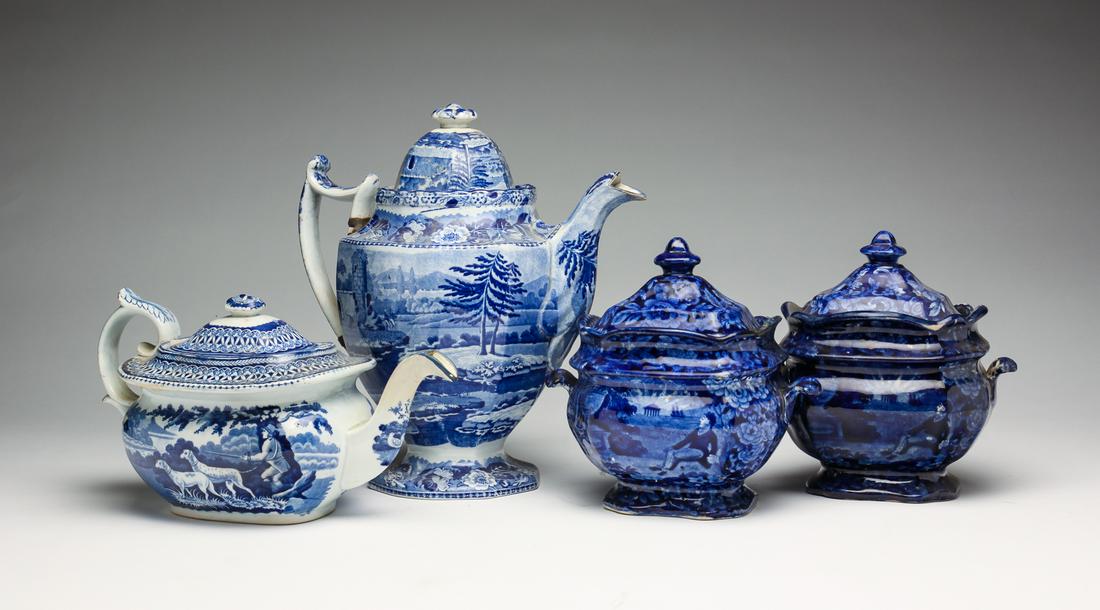 FOUR PIECES OF BLUE AND WHITE STAFFORDSHIRE.: England, second quarter 19th century. Two lidded sugars depicting "Lafayette at Franklin's Tomb". Wear, loss and crazing. 7.25"h. 6.75"w. Tall pot with traditional scenic view. Cracks, make-do repair 