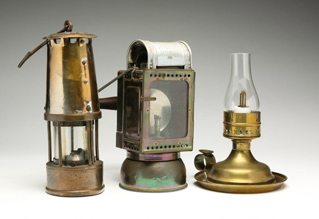THREE EUROPEAN LANTERNS.: Late 19th-2nd quarter 20th century. Two carbide lanterns. Brass German railroad lantern marked "JC Giessing Nurnberg 1939" with swastika and DR for Deutsche Reichsbahn. One red glass panel. 8.75"h. no