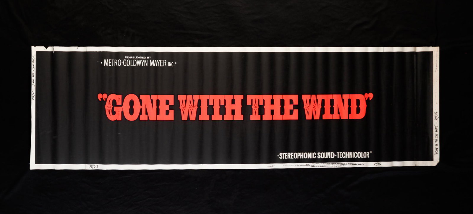 GONE WITH THE WIND MOVIE BANNER.: MGM, 1974. Original movie banner, rolled. Edge wear, tears and fading. 24"h. 82"w.