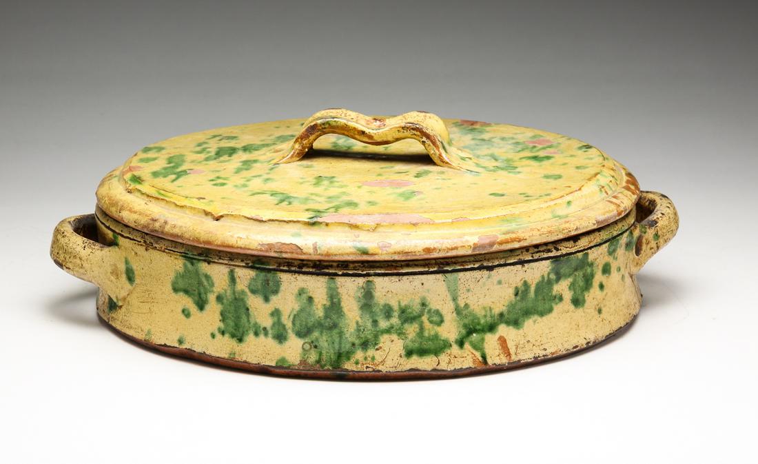 FRENCH REDWARE POACHING DISH.: Second half-19th century. Yellow slip with green accents. Round with handles and lid. Flaking and crack. 4.5"h. 12"d.