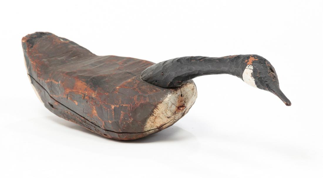 CANADA GOOSE DECOY.: Probably upper New York state or Canada, 1st half-20th century. Rough hewn body and extended neck. Life size with original paint. Wear. 31.5"l.